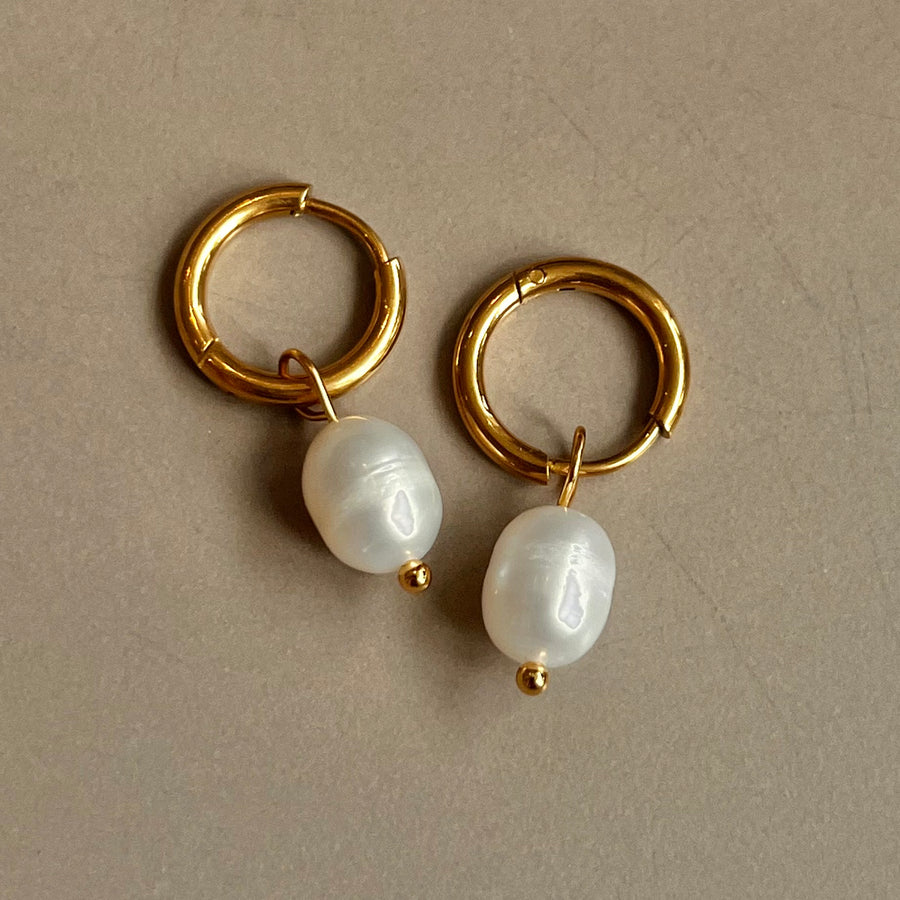 Luna Pearl Drop Huggies in silver: huggie hoops with a pearl drop