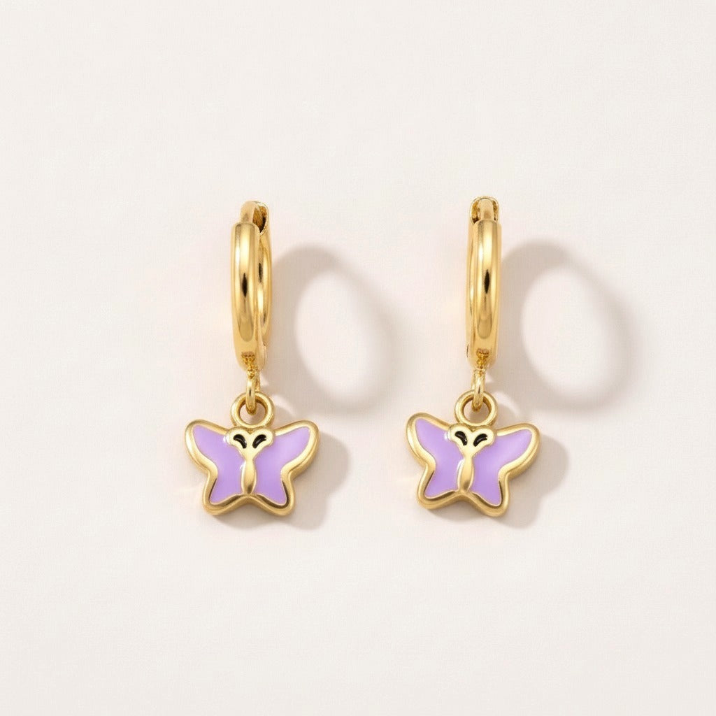 Butterfly Flutter Huggies Gold: hypoallergenic kids' huggie hoop earrings, shown front and side on a soft stone background