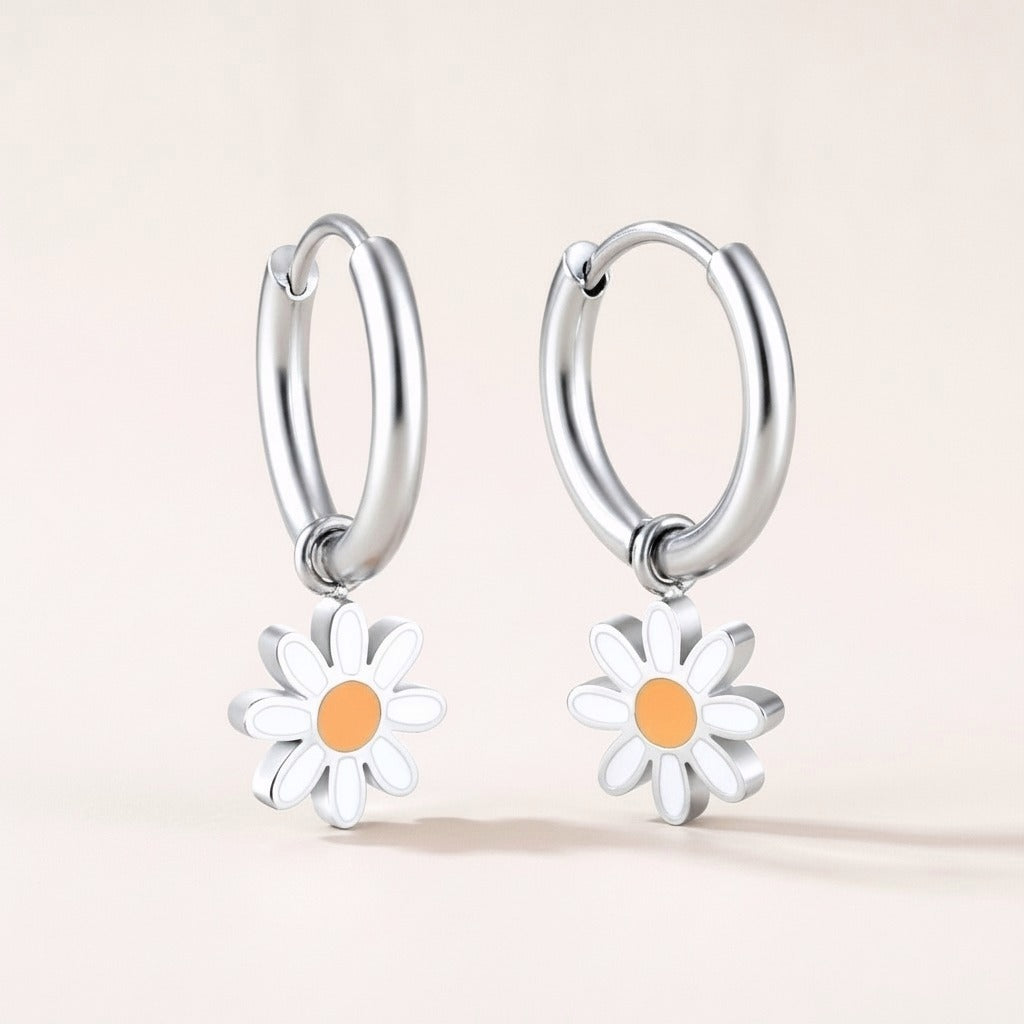 Daisy Day Huggies: hypoallergenic kids' huggie hoop earrings, shown front and side on a soft stone background