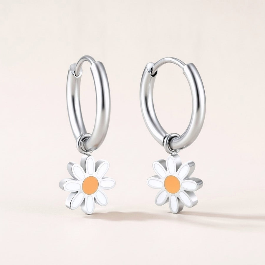 Daisy Day Huggies: hypoallergenic kids' huggie hoop earrings, shown front and side on a soft stone background