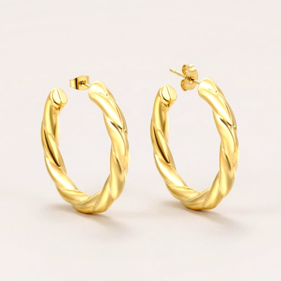 Big Twisted Hoops: hypoallergenic hoop earrings, shown front and side on a soft stone background