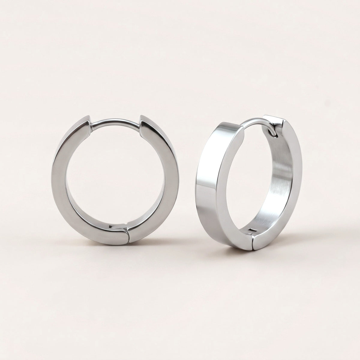 Classic Sleek Hoops Silver: hypoallergenic hoop earrings, shown front and side on a soft stone background