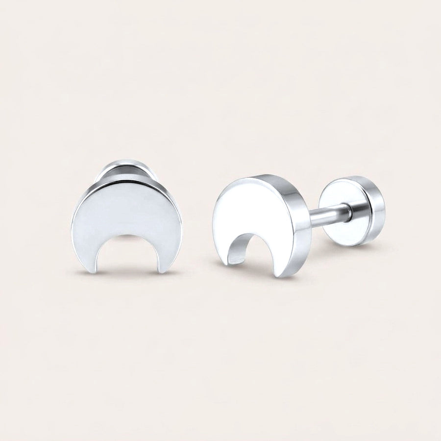 Crescent Flat Back Stud Silver: hypoallergenic kids' flat back stud earrings, shown front and side on a soft stone background