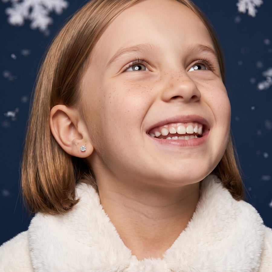 Diamond CZ Flat Back Studs Silver worn by a smiling girl, winter look: hypoallergenic kids' earrings