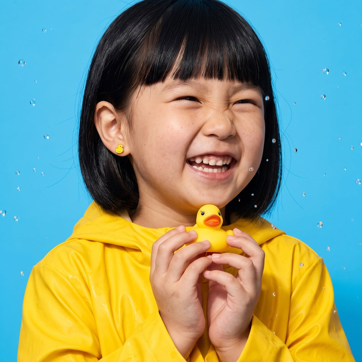 Ducky Flat Back Studs worn by a smiling girl, bath time look: hypoallergenic kids' earrings