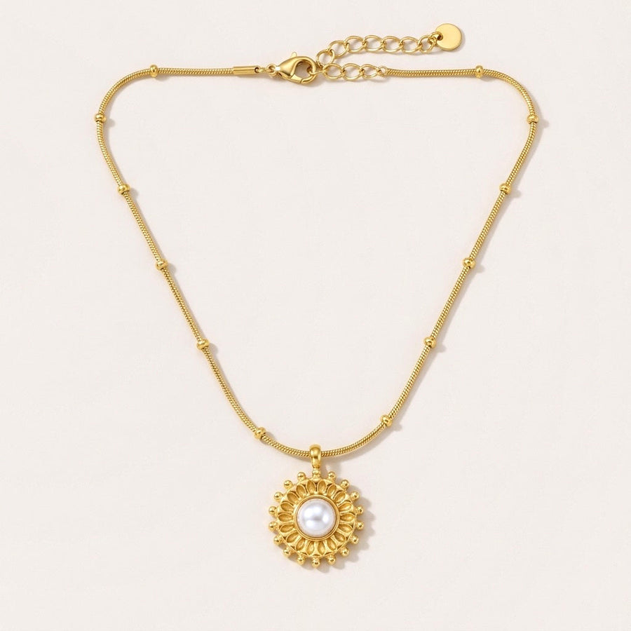 Golden Glow Pearl Pendant: hypoallergenic necklace, shown front and side on a soft stone background