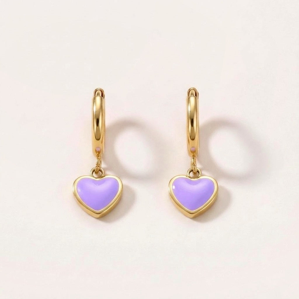 Heart Huggies Gold in Lilac: hypoallergenic kids' huggie hoop earrings, shown front and side on a soft stone background
