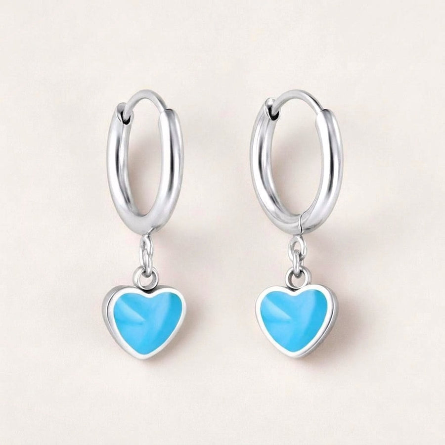 Heart Huggies Silver in Turquoise: hypoallergenic kids' huggie hoop earrings, shown front and side on a soft stone background
