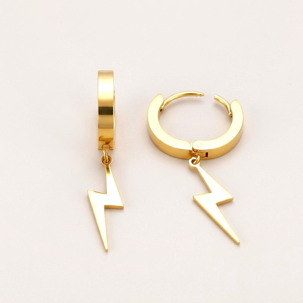 Lighting Bolt Huggies: hypoallergenic huggie hoop earrings, shown front and side on a soft stone background