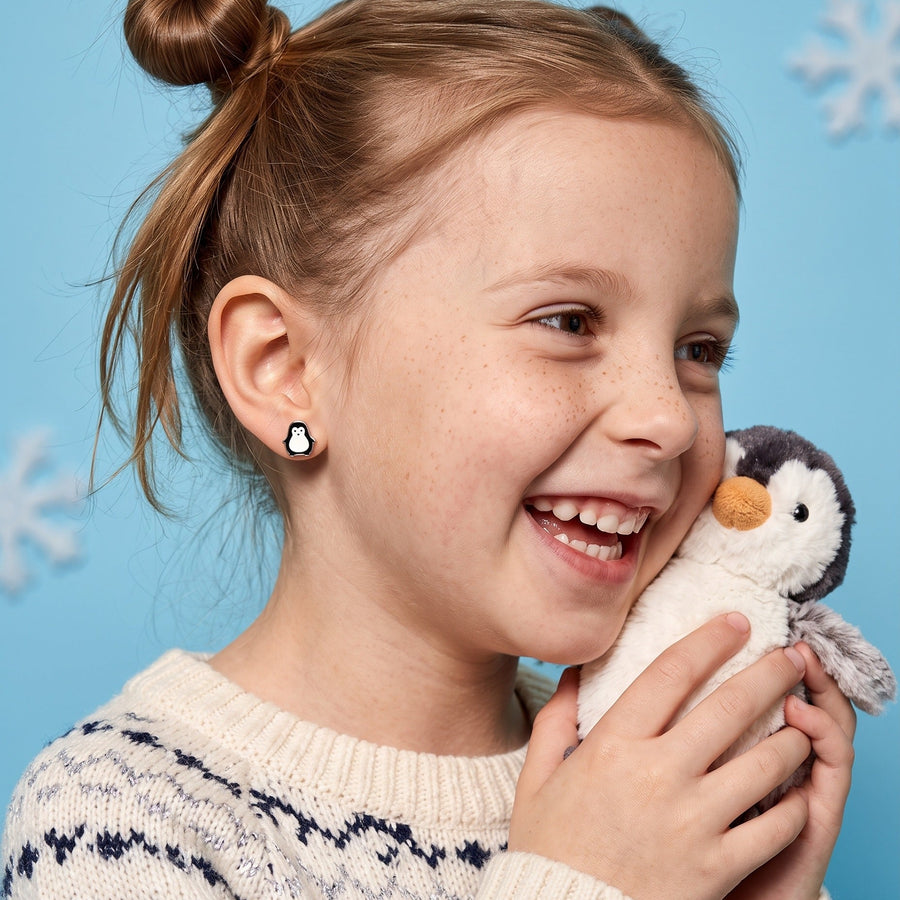 Penguin Flat Back Studs Silver worn by a smiling girl, winter look: hypoallergenic kids' earrings