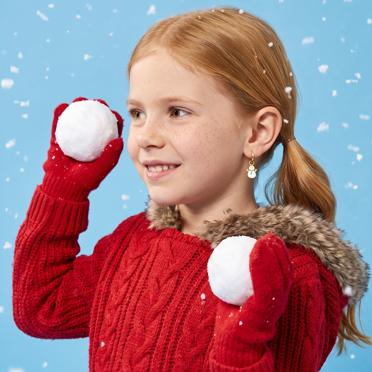 Snowman Huggies worn by a smiling girl, winter look: hypoallergenic kids' earrings