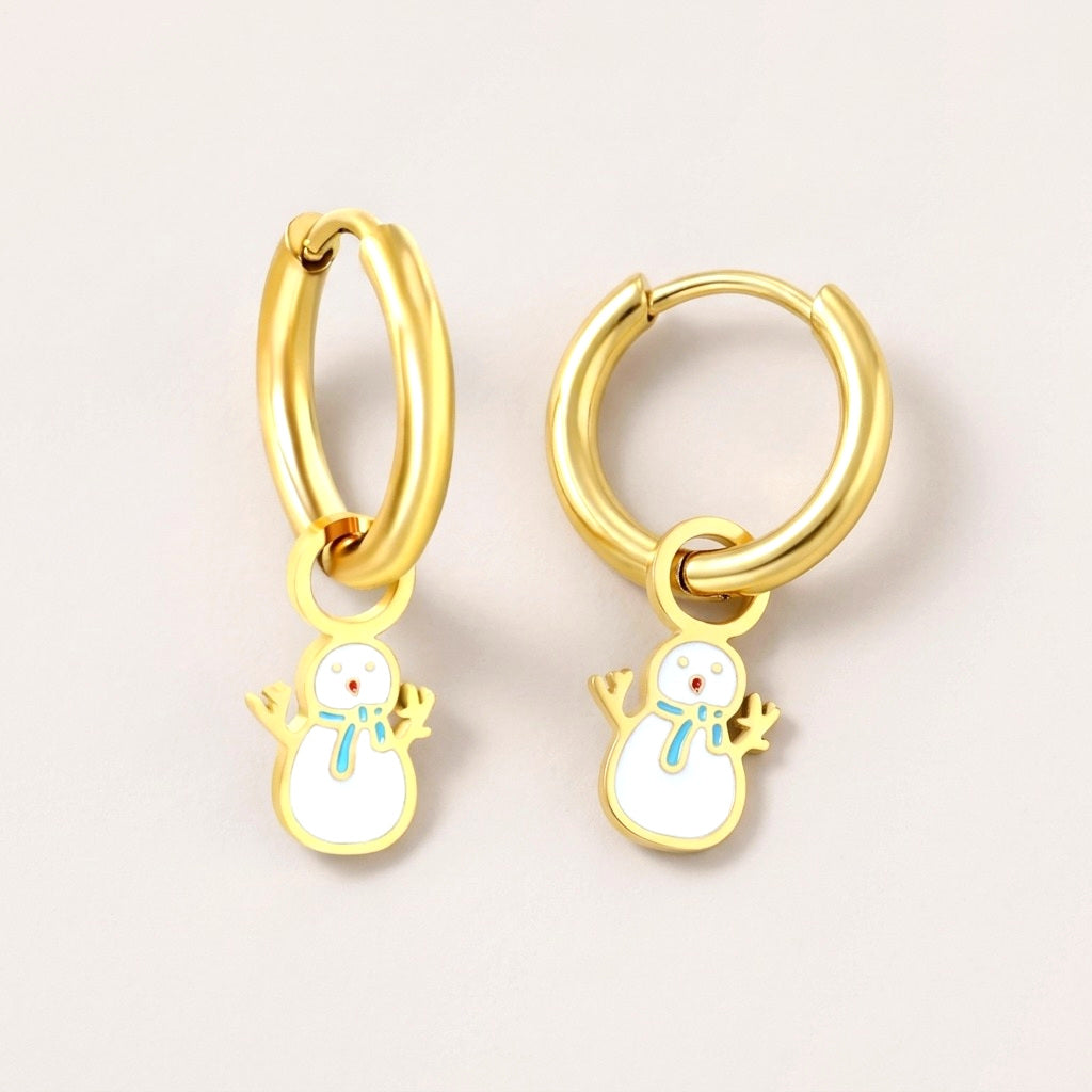 Snowman Huggies: hypoallergenic kids' huggie hoop earrings, shown front and side on a soft stone background