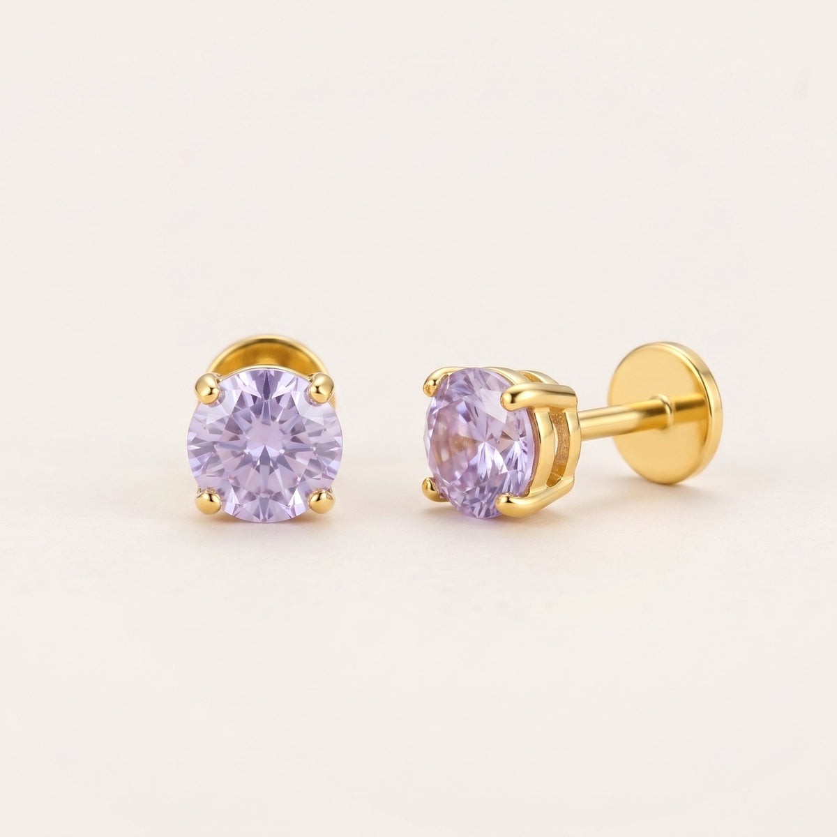 The Birthstone Flat Back Studs Gold in Alexandrite: hypoallergenic kids' flat back stud earrings, shown front and side on a soft stone background