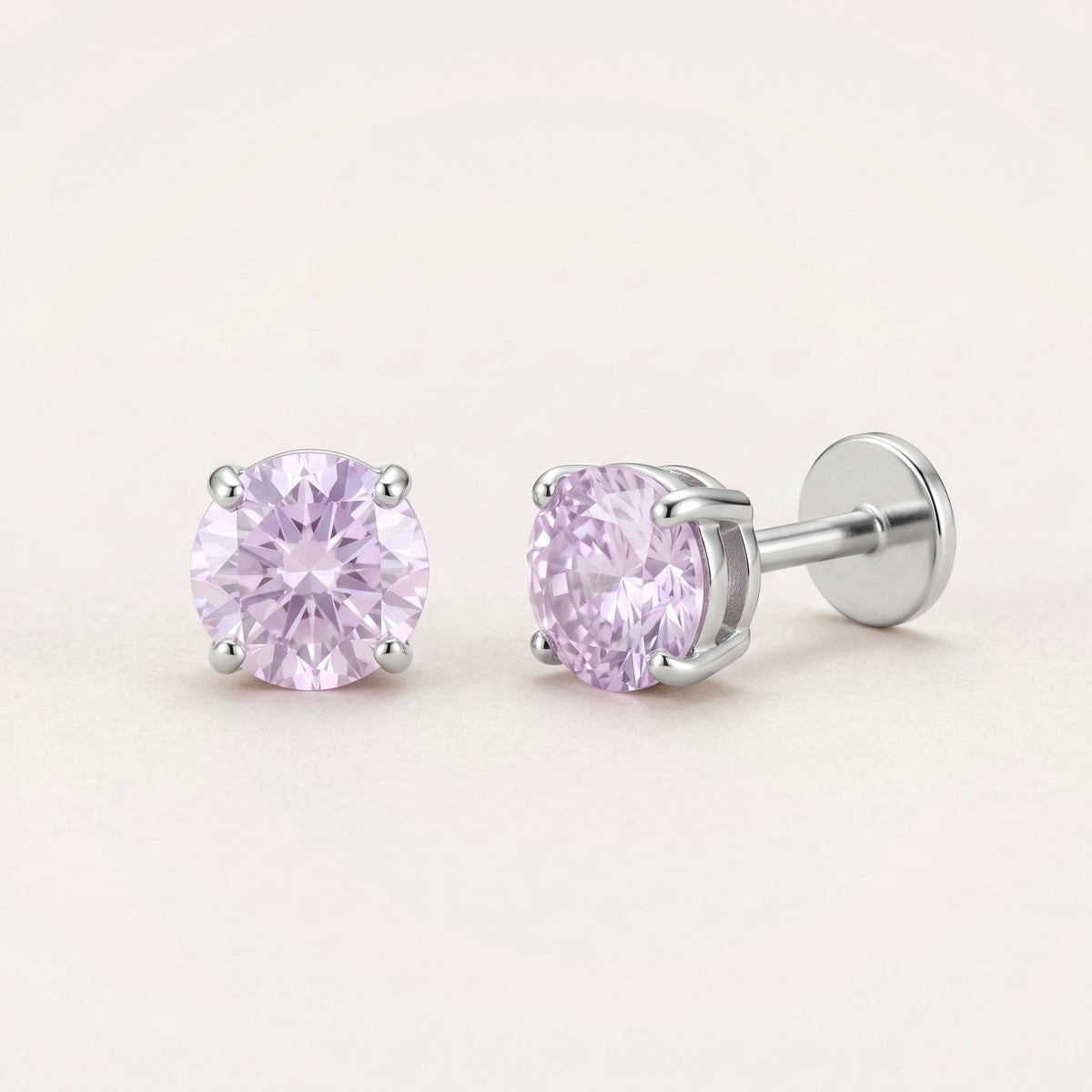 The Birthstone Flat Back Studs Silver in Amethyst: hypoallergenic kids' flat back stud earrings, shown front and side on a soft stone background