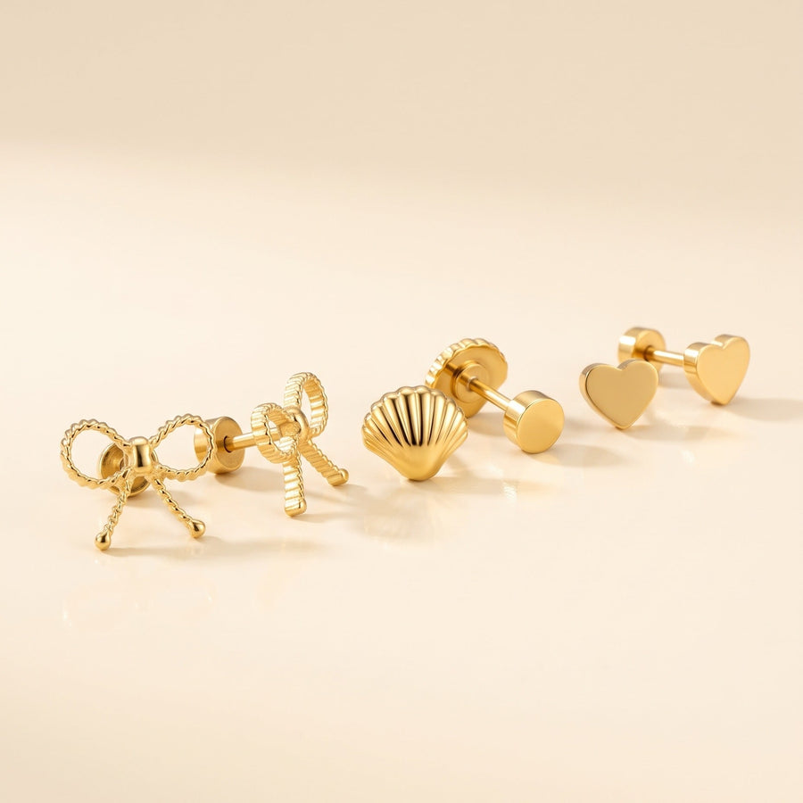 Ribbon Bow Flat Backs + Seashell Flat Back Stud Gold + Classic Heart Flat Backs Gold: three hypoallergenic kids' earrings styled together on a soft background