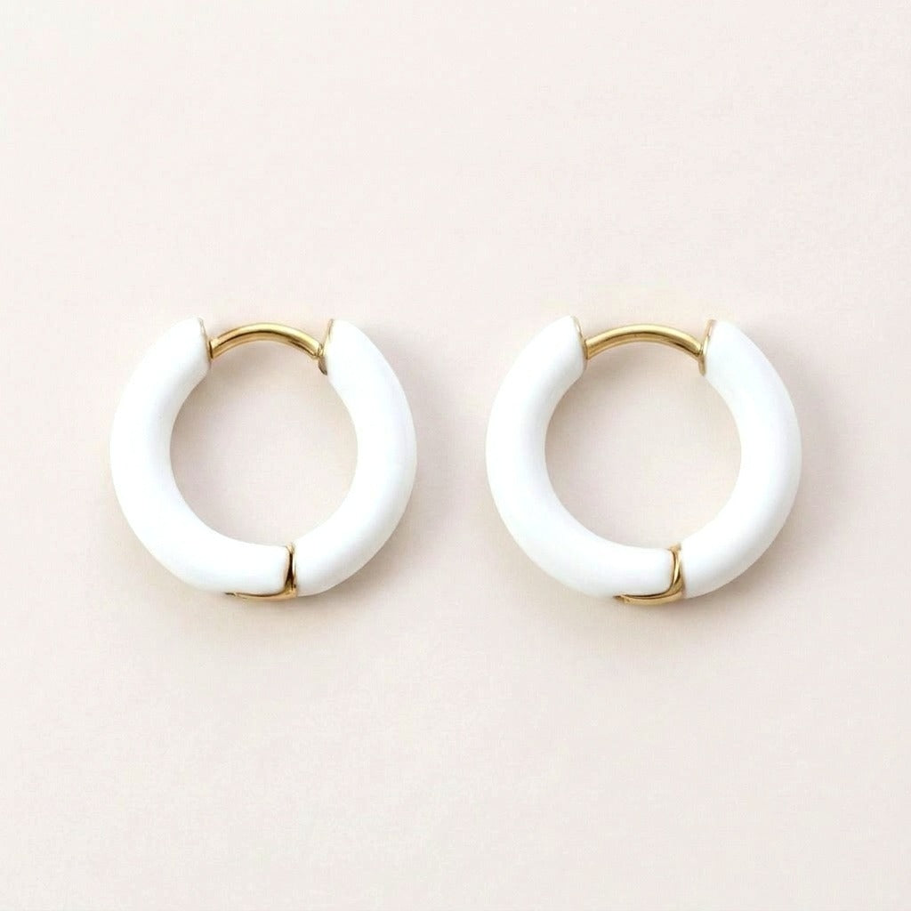 Enamel Pop Hoops White: hypoallergenic kids' huggie hoop earrings, shown front and side on a soft stone background
