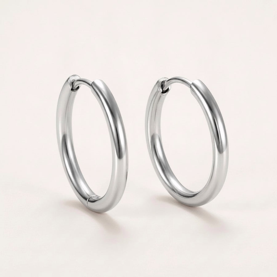 Everyday Hoops Silver: hypoallergenic kids' hoop earrings, shown front and side on a soft stone background