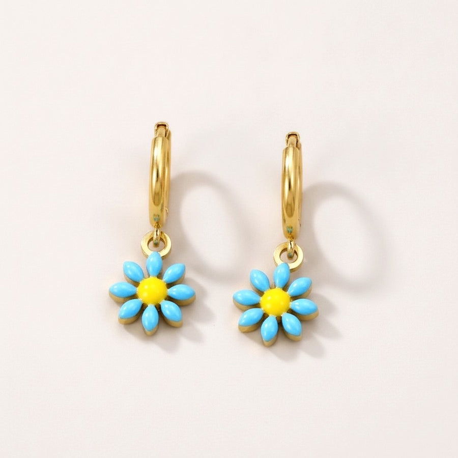Flower Bloom Huggies: hypoallergenic kids' huggie hoop earrings, shown front and side on a soft stone background