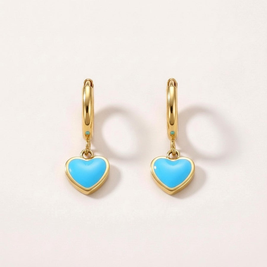 Heart Huggies Gold: hypoallergenic kids' huggie hoop earrings, shown front and side on a soft stone background