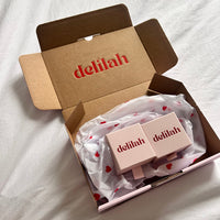 Open box with 'delilah' branding on a white background
