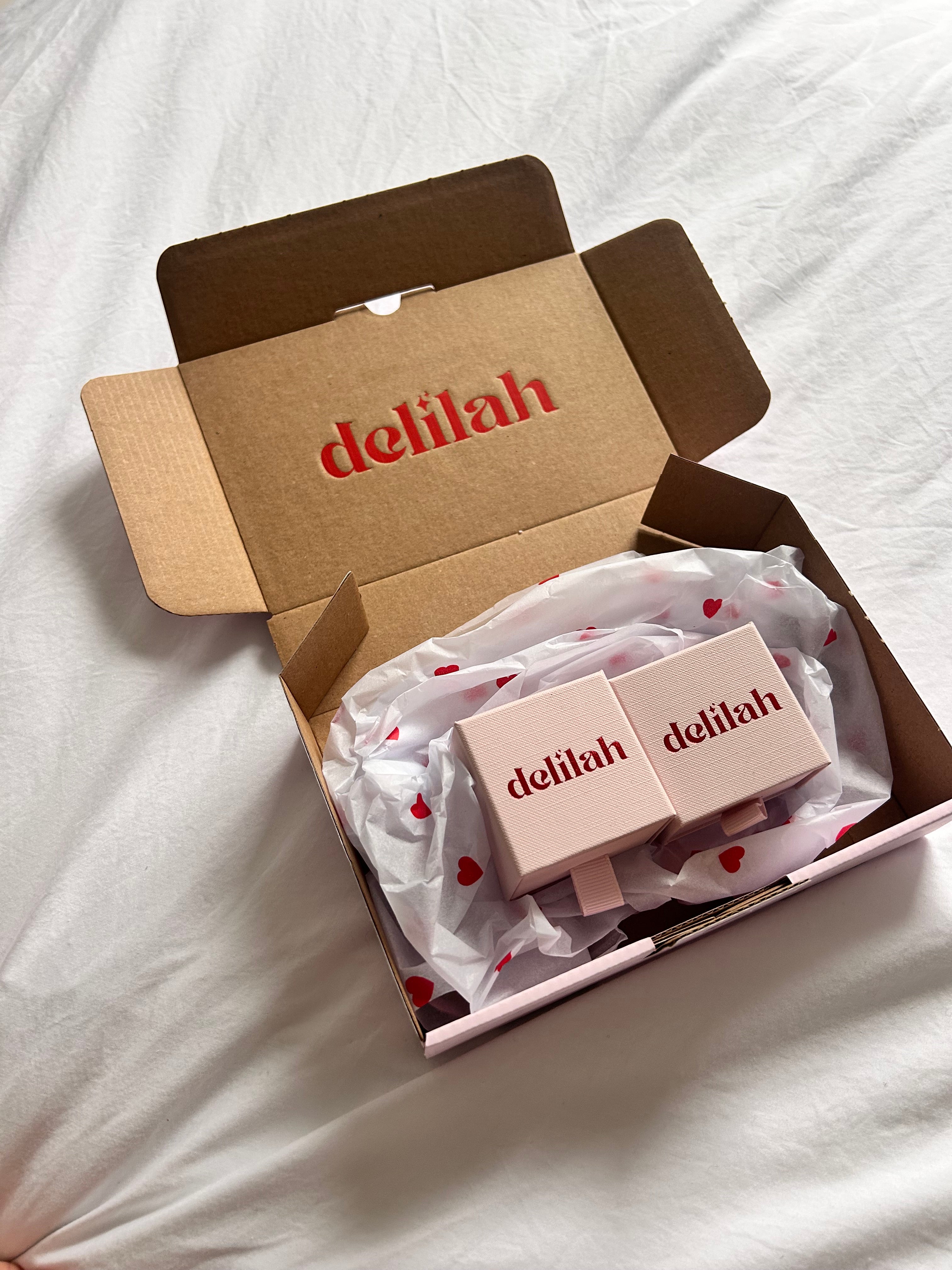 Open box with 'delilah' branding on a white background