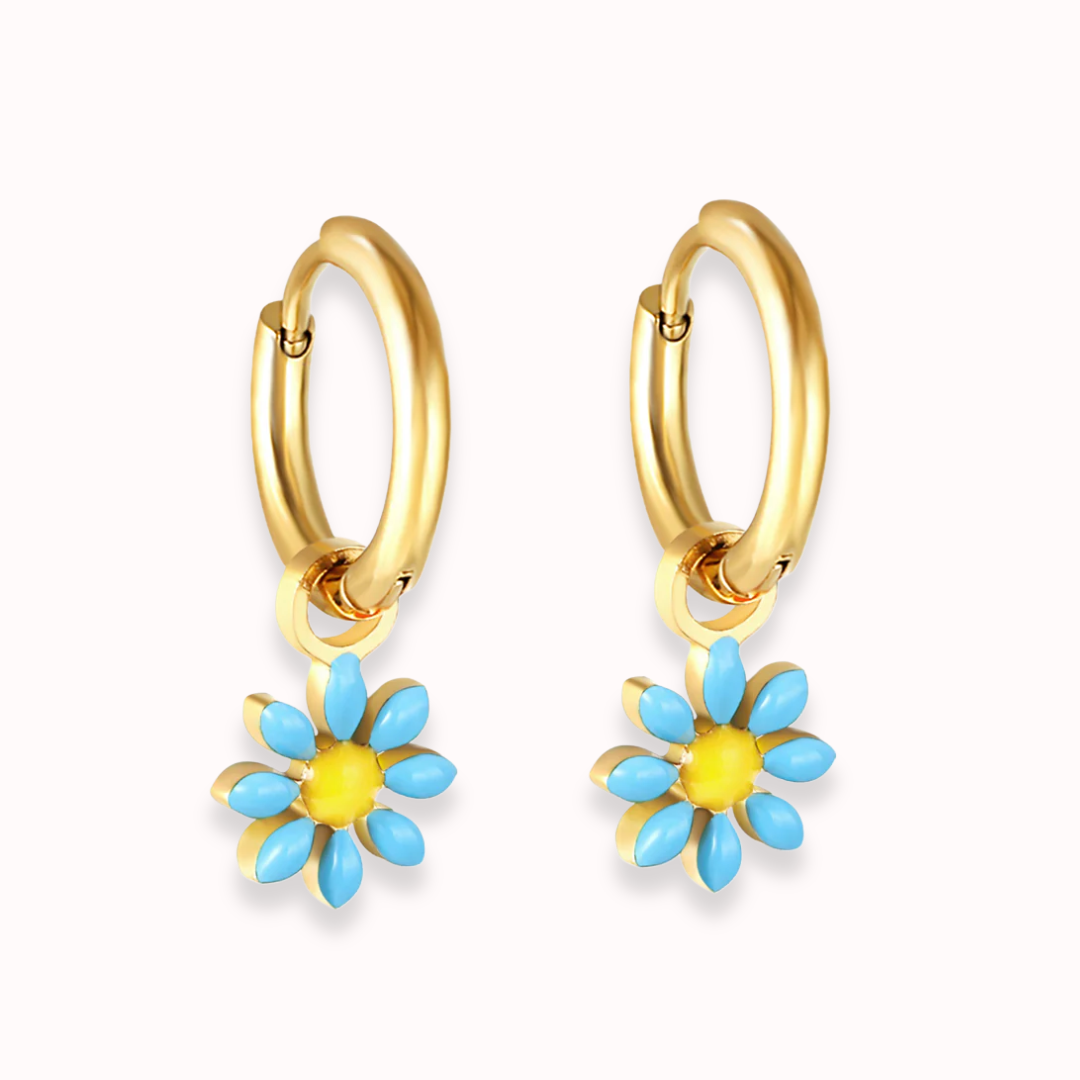 Gold hoop earrings with blue and yellow flower charms on a white background