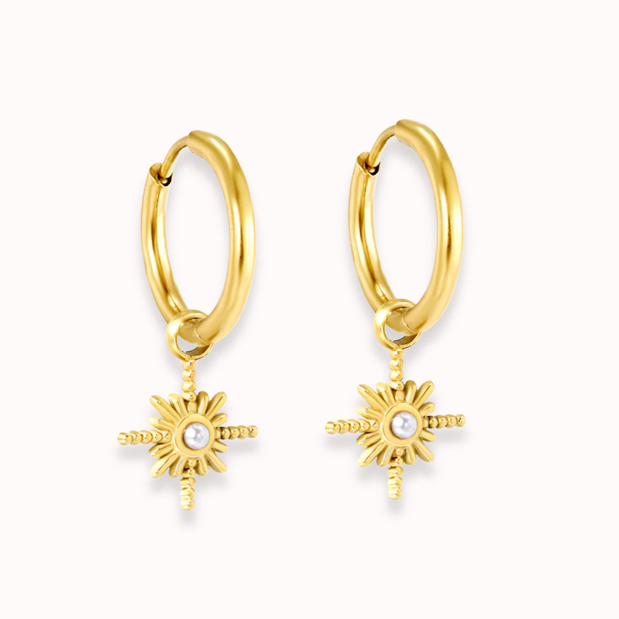 Starbeam Huggies: gold huggie hoops with a north star charm and pearl centre