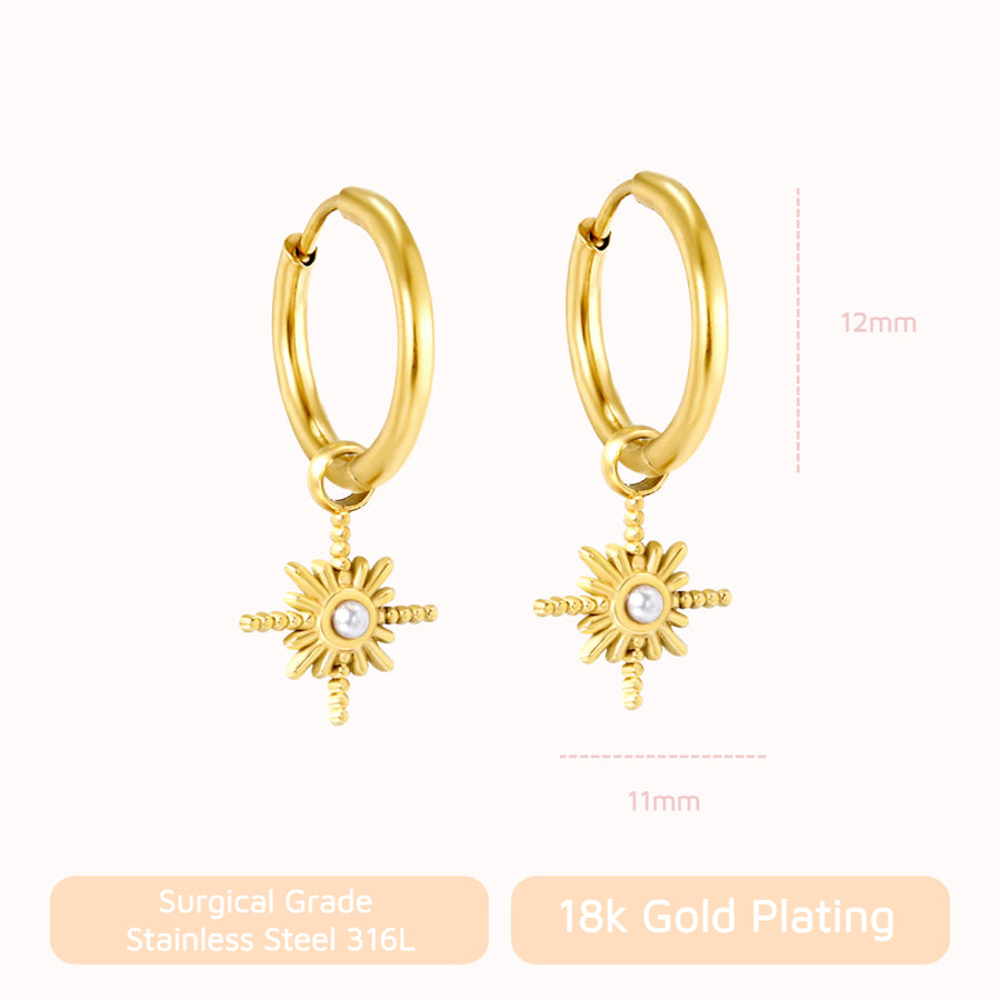 Starbeam Huggies: gold huggie hoops with a north star charm and pearl centre