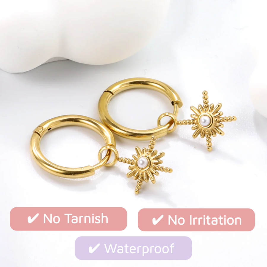 Starbeam Huggies: gold huggie hoops with a north star charm and pearl centre