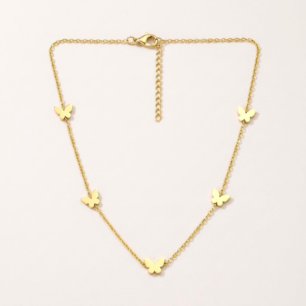 Butterfly Necklace: hypoallergenic kids' necklace, laid flat on a soft stone background