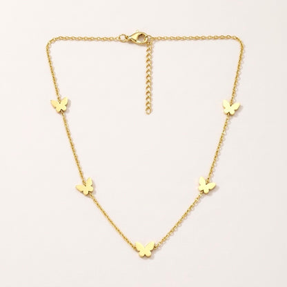 Butterfly Necklace: hypoallergenic kids' necklace, laid flat on a soft stone background