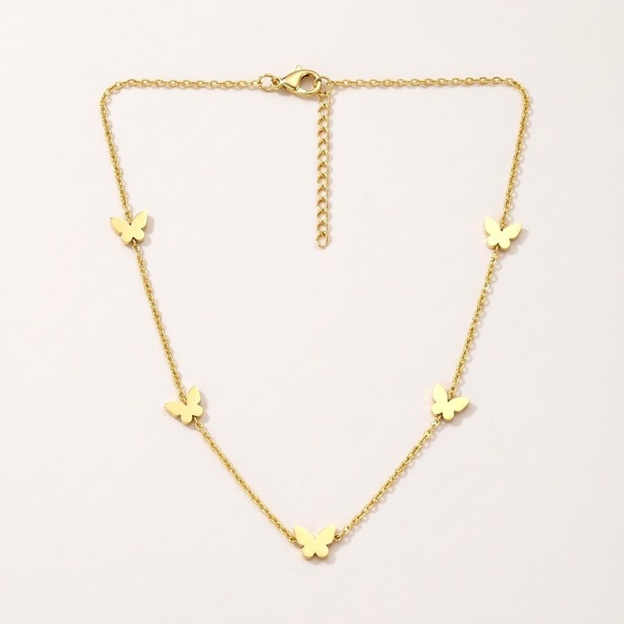 Butterfly Necklace: hypoallergenic kids' necklace, laid flat on a soft stone background