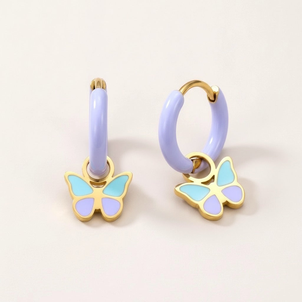 Butterfly Pop Huggies: hypoallergenic kids' huggie hoop earrings, shown front and side on a soft stone background