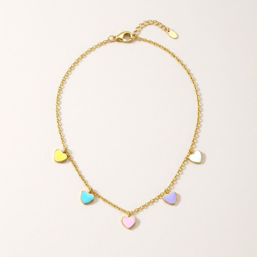 Candy Hearts Necklace: hypoallergenic kids' necklace, laid flat on a soft stone background