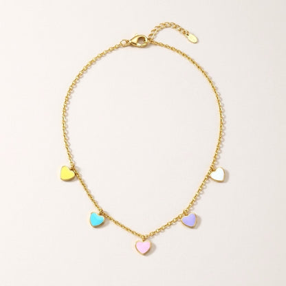 Candy Hearts Necklace: hypoallergenic kids' necklace, laid flat on a soft stone background