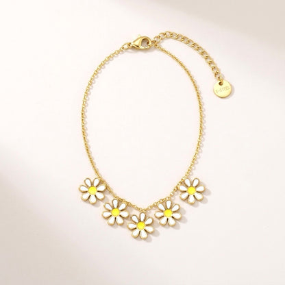 Daisy Chain Necklace: hypoallergenic kids' necklace, laid flat on a soft stone background