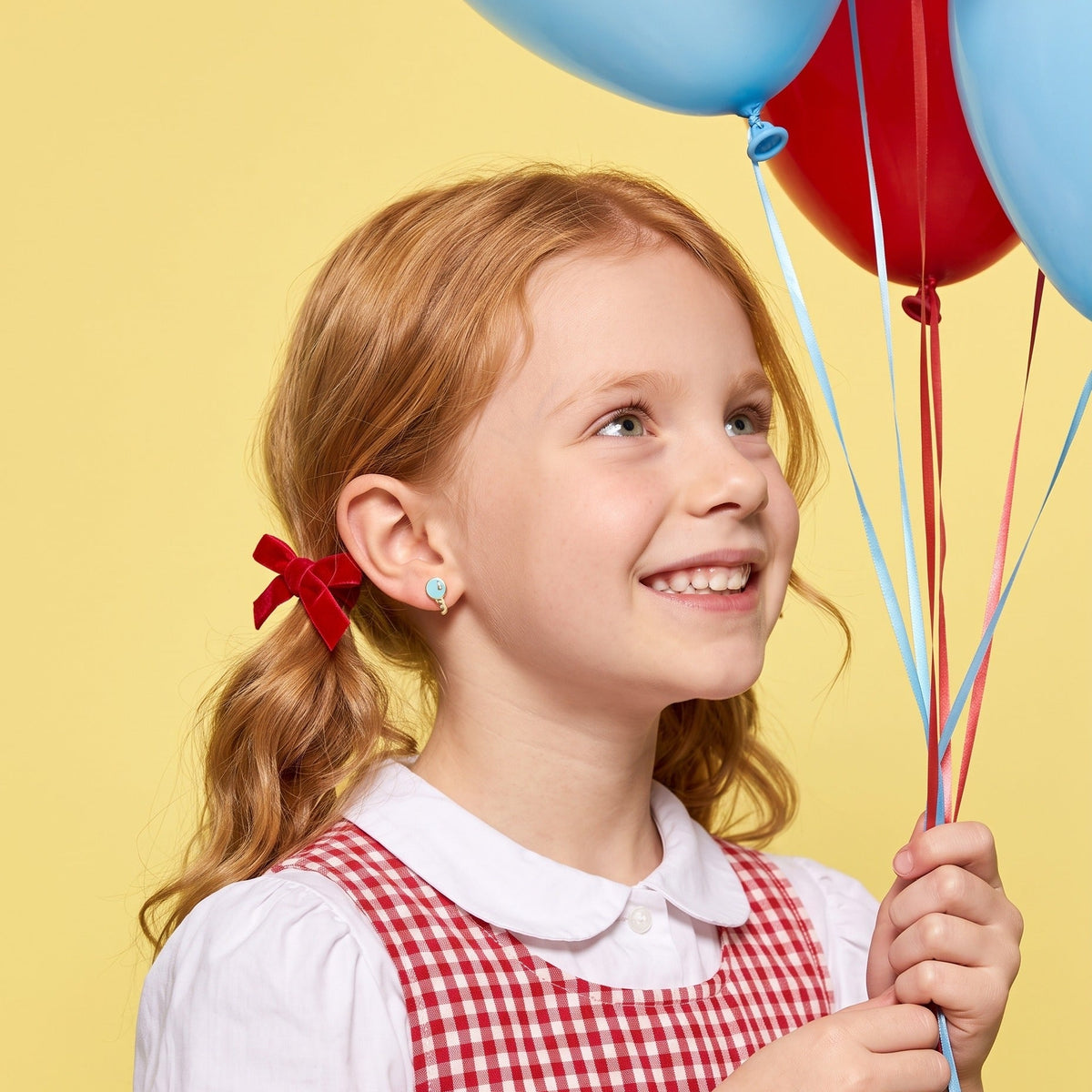 Balloon Pop Flat Back Studs worn by a smiling girl, party look: hypoallergenic kids' earrings