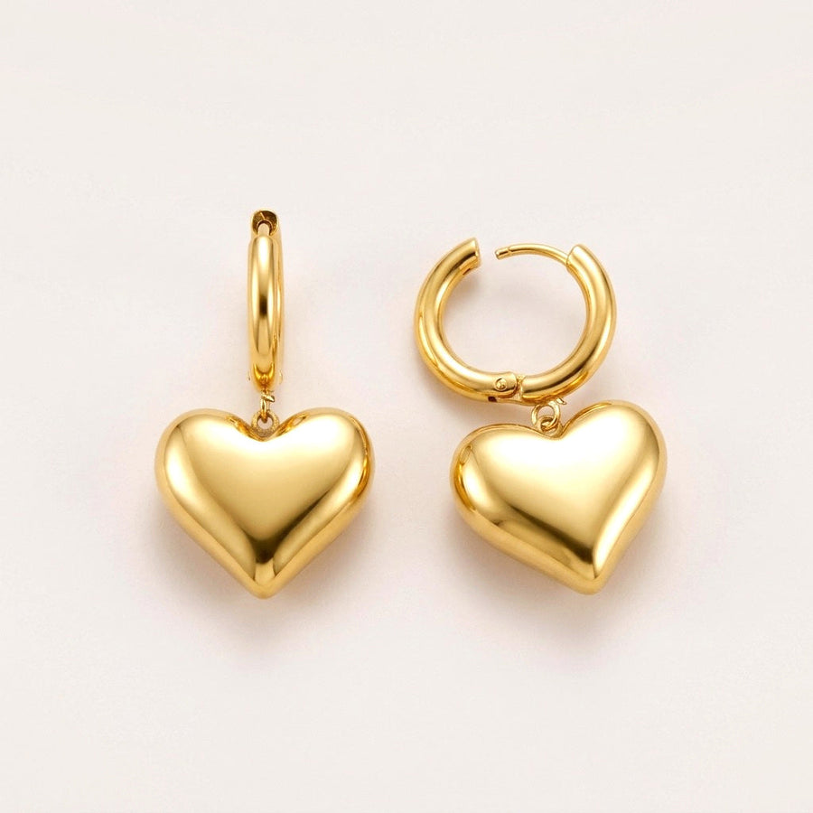 Big Love Heart Huggies: hypoallergenic huggie hoop earrings, shown front and side on a soft stone background