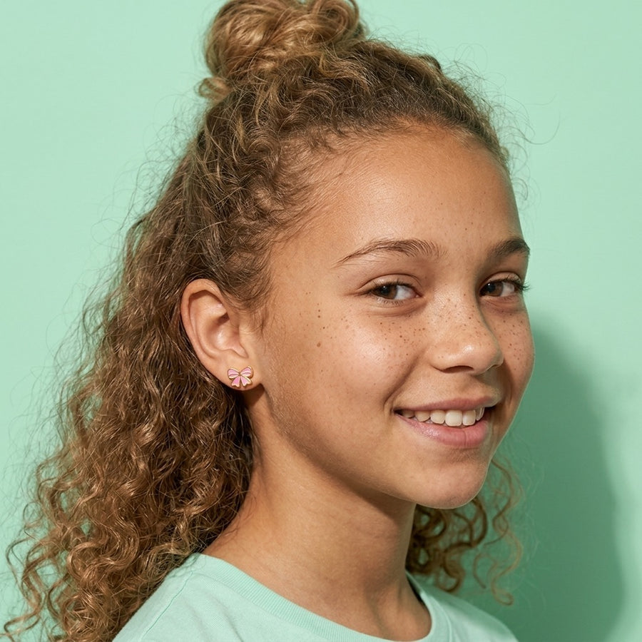 Candy Bow Flat Back Studs worn by a smiling girl