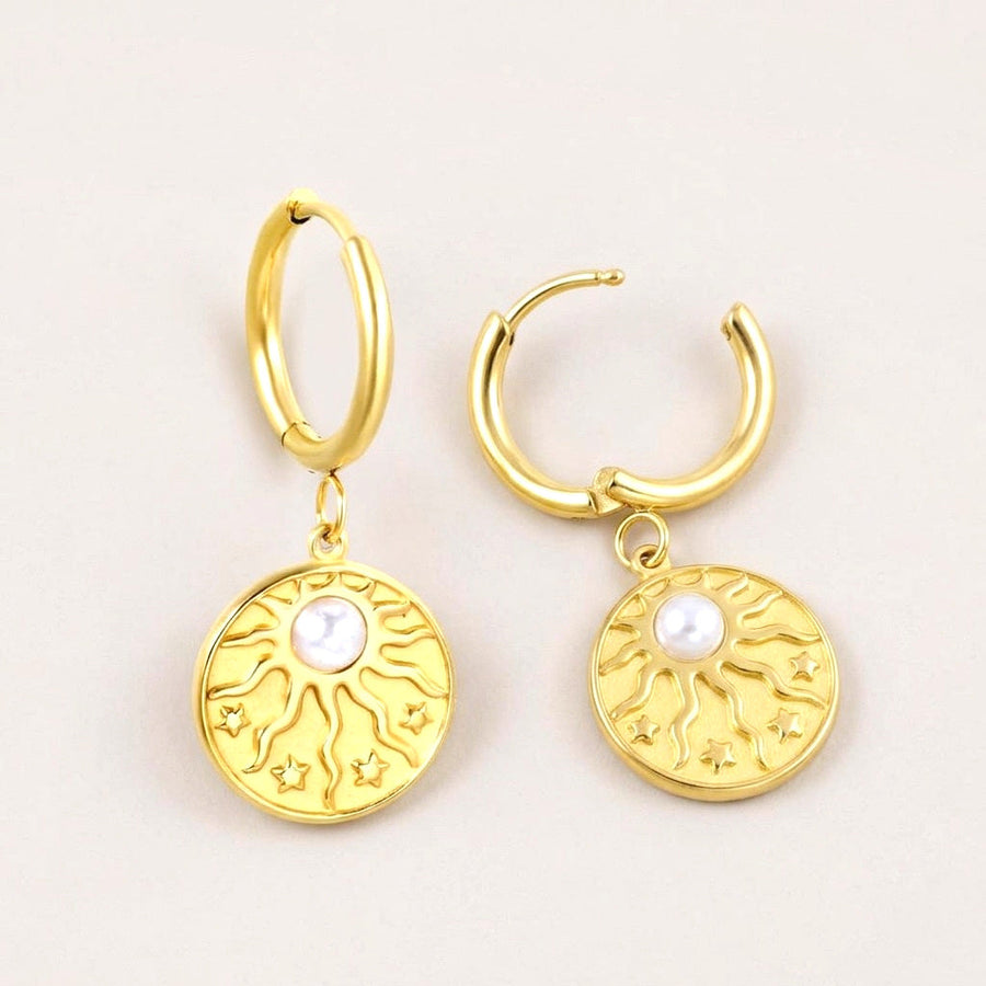 Celeste Coin Golden Huggies: hypoallergenic huggie hoop earrings, shown front and side on a soft stone background