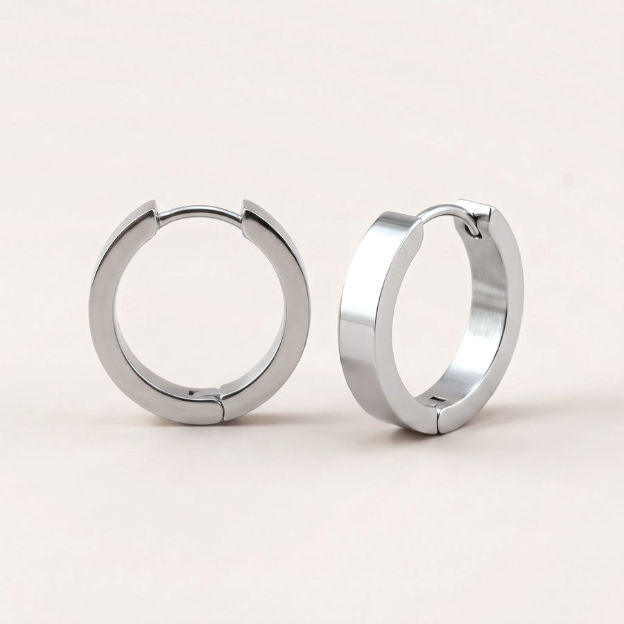 Classic Sleek Hoops Silver: hypoallergenic hoop earrings, shown front and side on a soft stone background