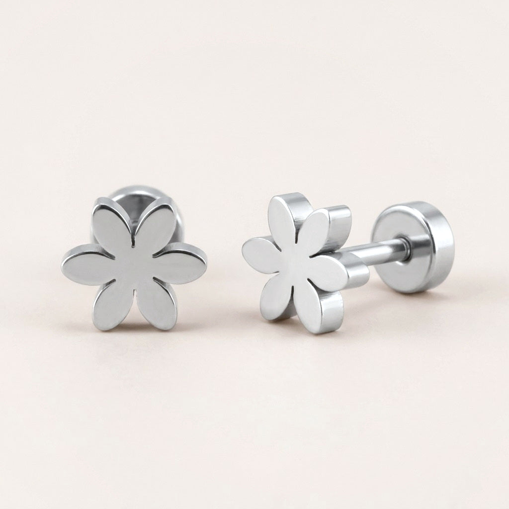 Flower Flat Back Studs Silver: hypoallergenic kids' flat back stud earrings, shown front and side on a soft stone background