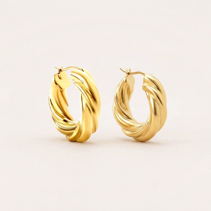 Golden Twist Hoops: hypoallergenic hoop earrings, shown front and side on a soft stone background