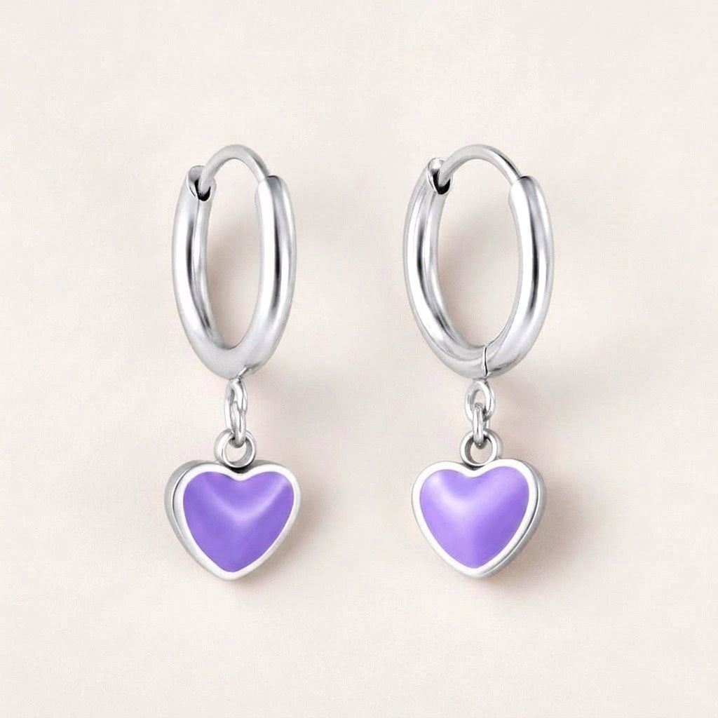 Heart Huggies Silver in Lilac: hypoallergenic kids' huggie hoop earrings, shown front and side on a soft stone background