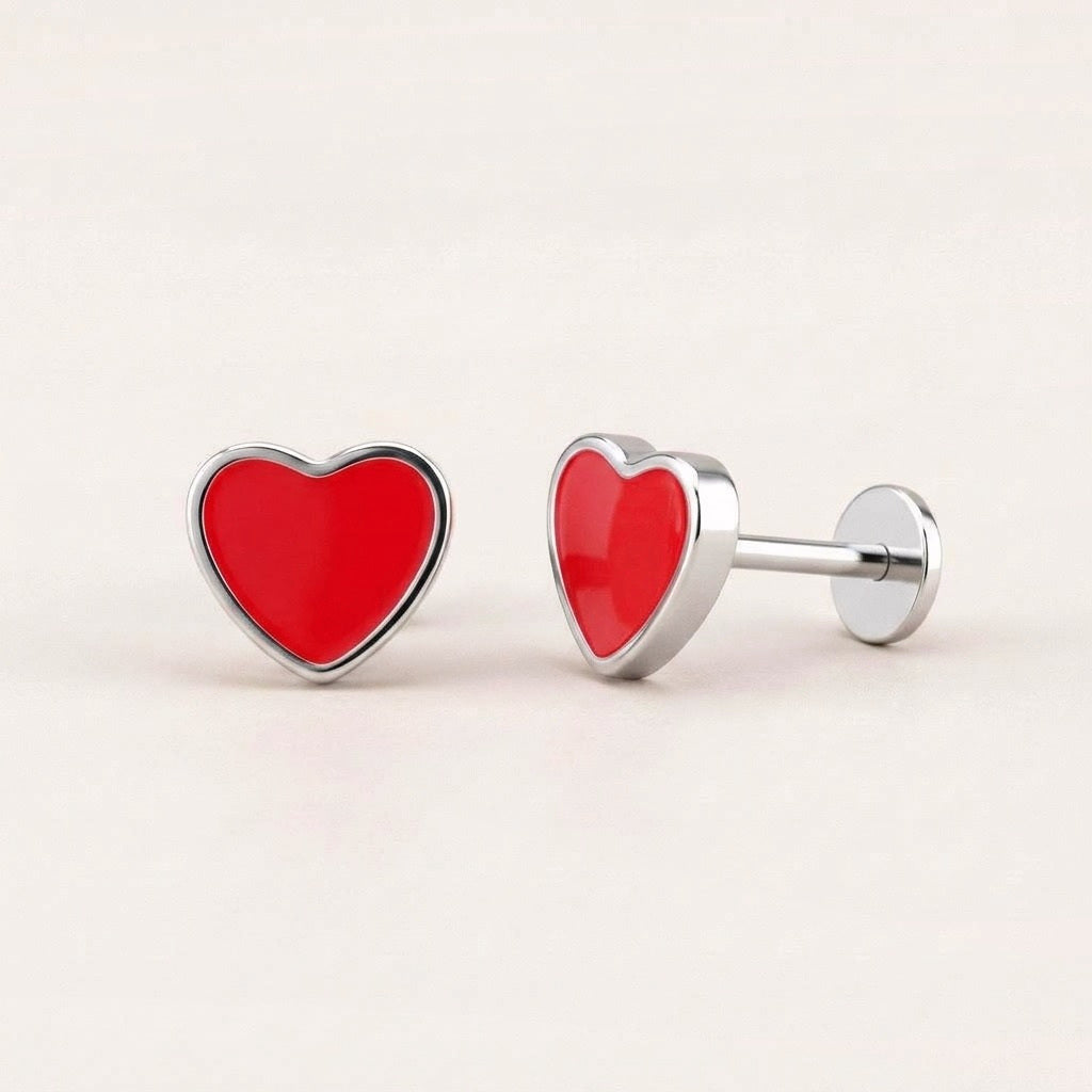 Love Heart Flat Back Studs Silver in Red: hypoallergenic kids' flat back stud earrings, shown front and side on a soft stone background