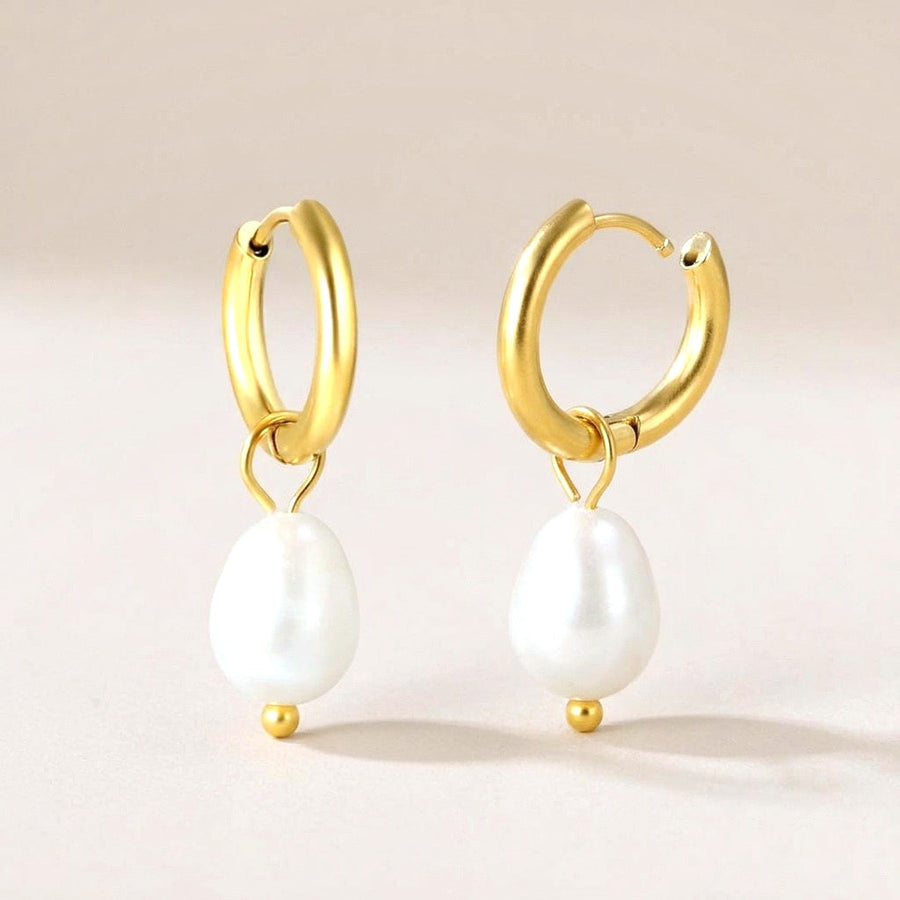 Luna Pearl Drop Huggies Gold: hypoallergenic huggie hoop earrings, shown front and side on a soft stone background