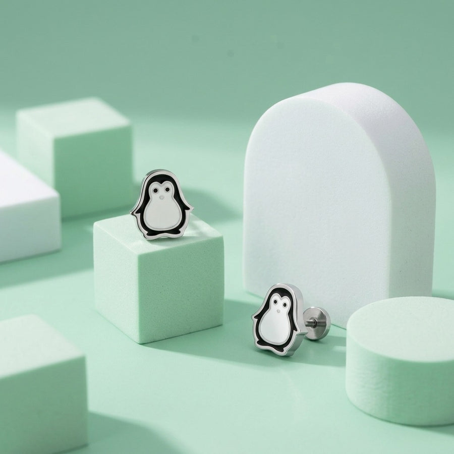 Penguin Flat Back Studs Silver styled on pastel blocks, front and side view