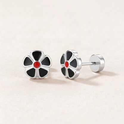 Petal Flower Flat Back Studs Silver in Black: hypoallergenic kids' flat back stud earrings, shown front and side on a soft stone background