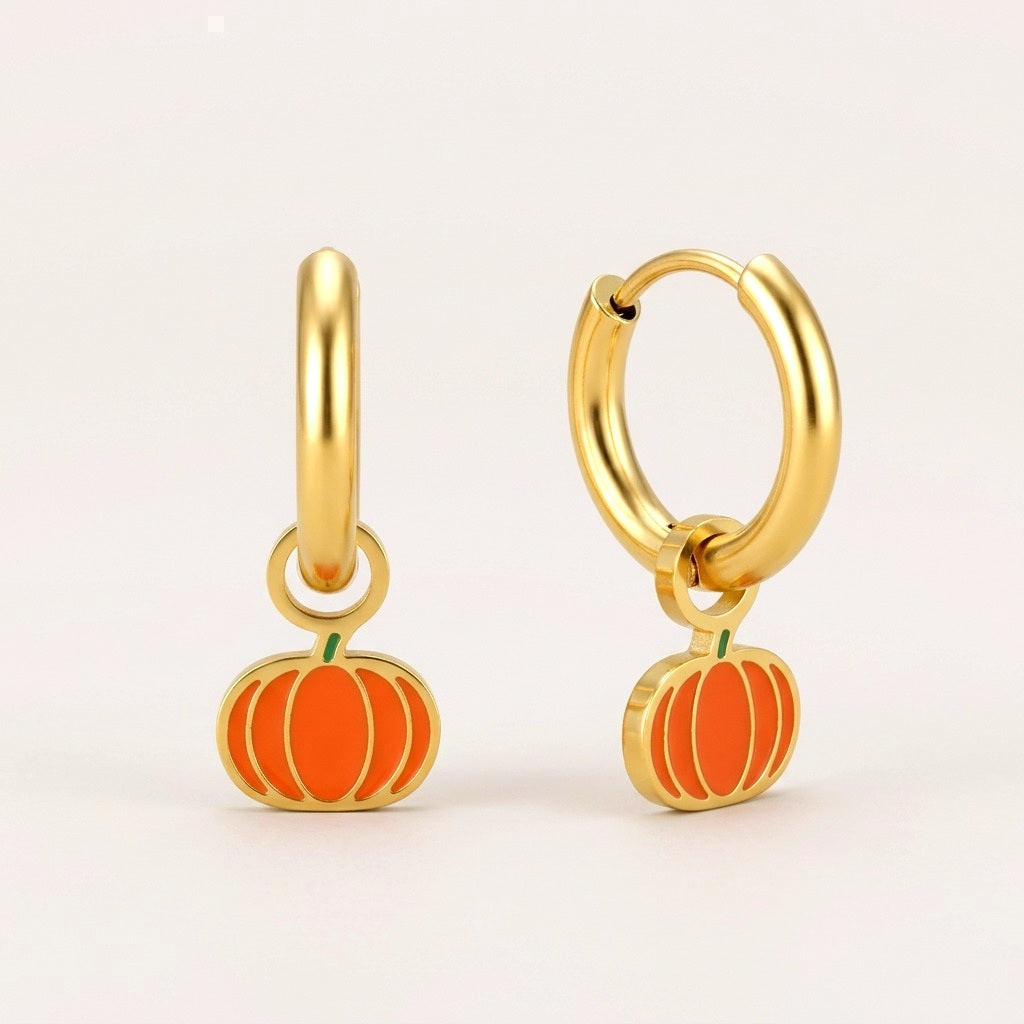 Pumpkin Spice Huggies: hypoallergenic kids' huggie hoop earrings, shown front and side on a soft stone background