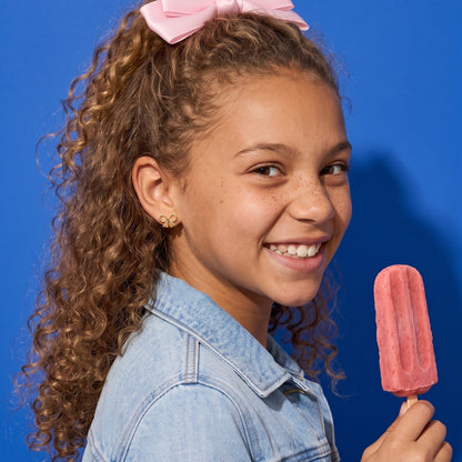Ribbon Bow Flat Backs worn by a smiling girl, denim bow look: hypoallergenic kids' earrings